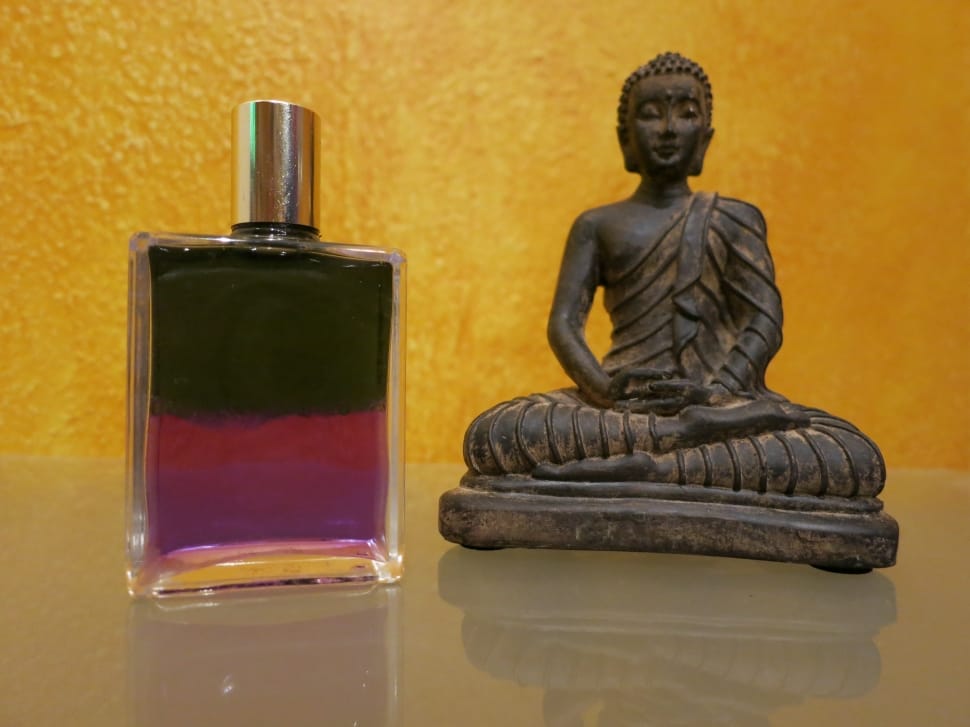 hindu deity figurine and glass spray bottle preview