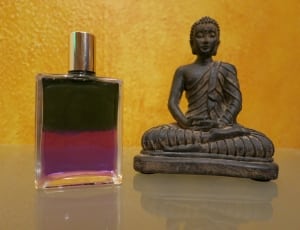hindu deity figurine and glass spray bottle thumbnail