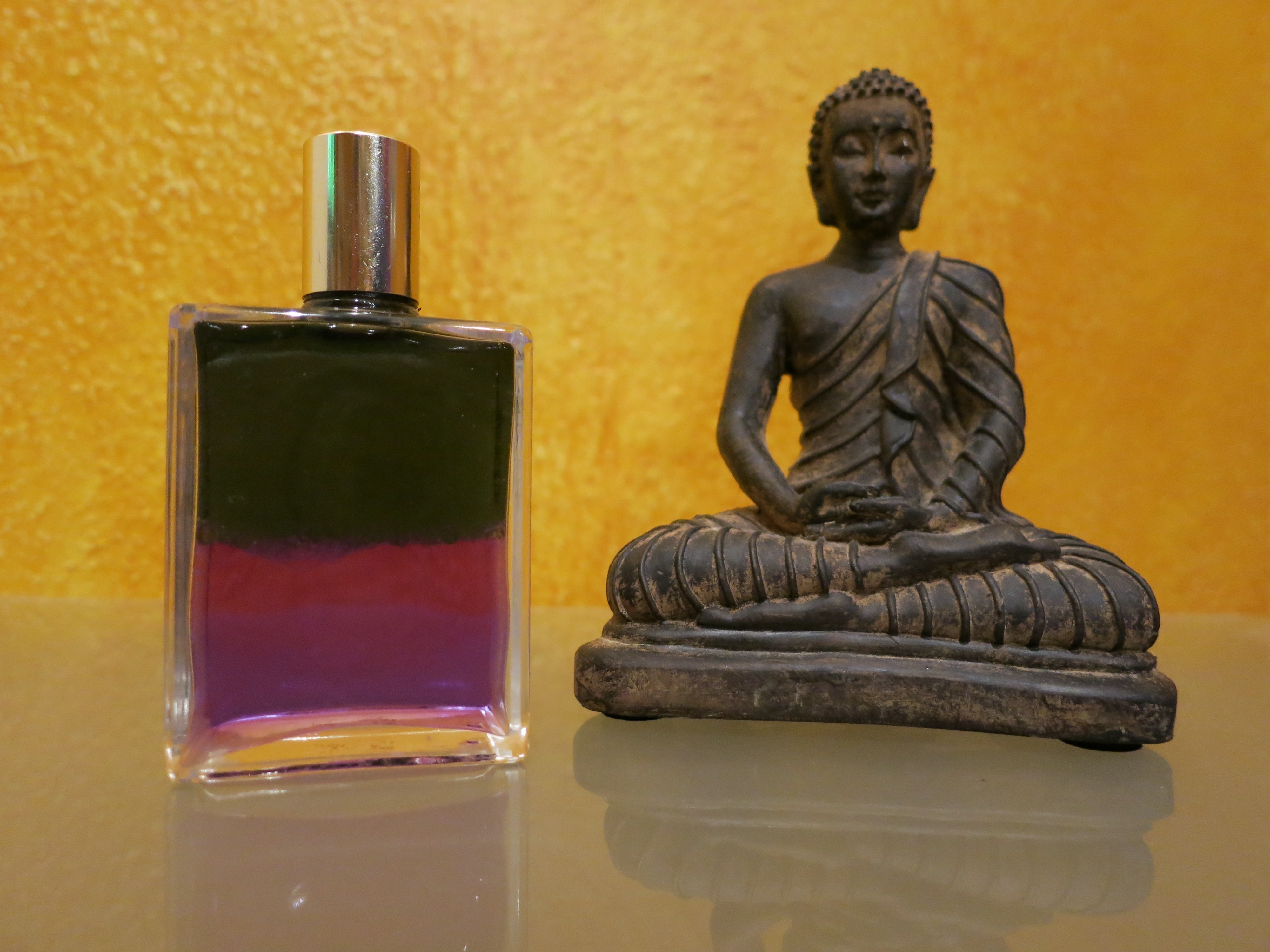 hindu deity figurine and glass spray bottle