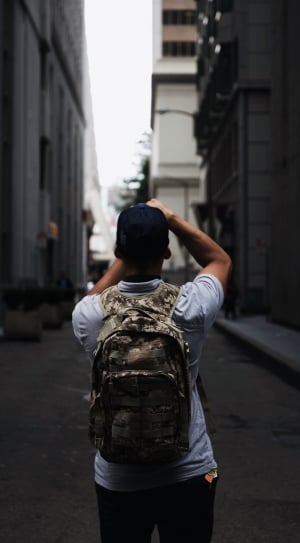 person wearing gray and green camouflage backpack thumbnail