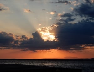 sun setting covered by clouds over the horizon image thumbnail
