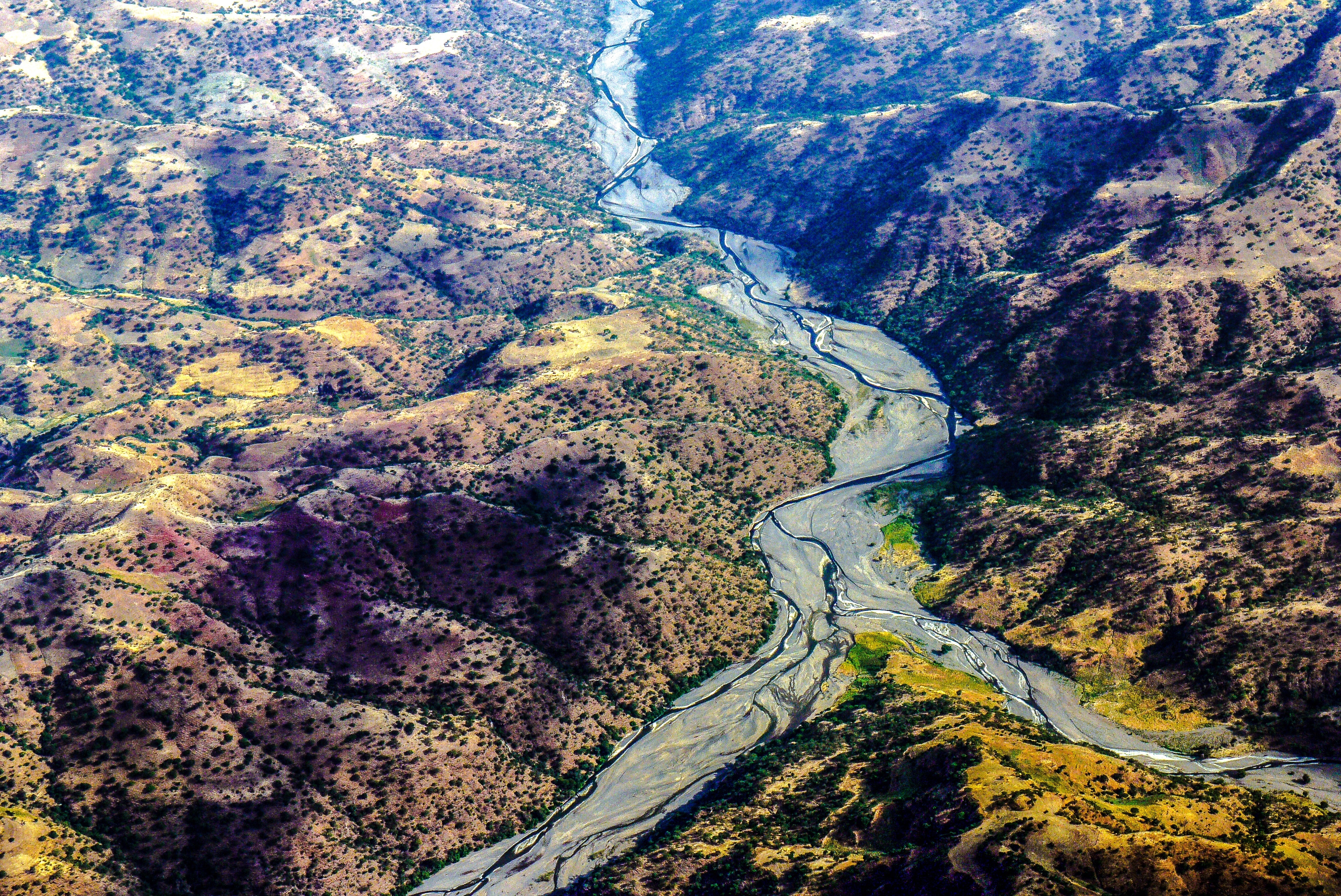 aerial photo of river surrounded by rock formation