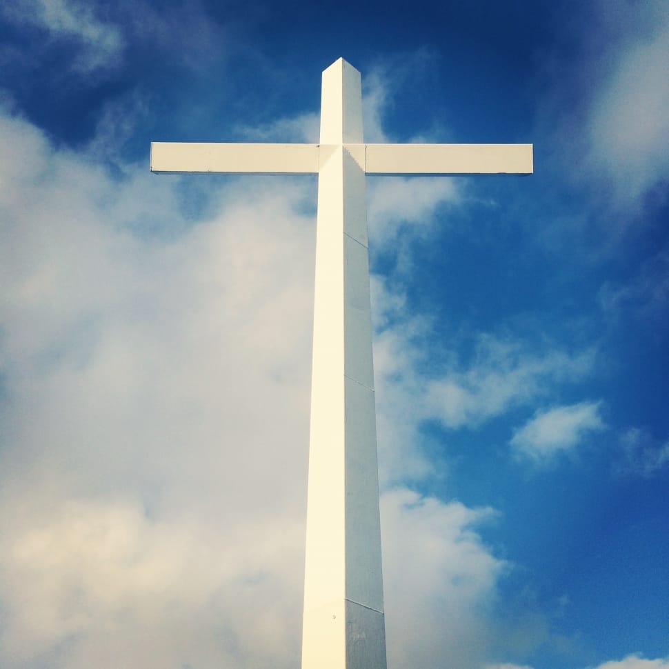 white gothic cross and blue sky preview