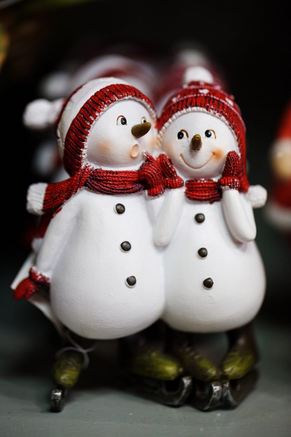 two snowman ceramic figurine on gray surface preview