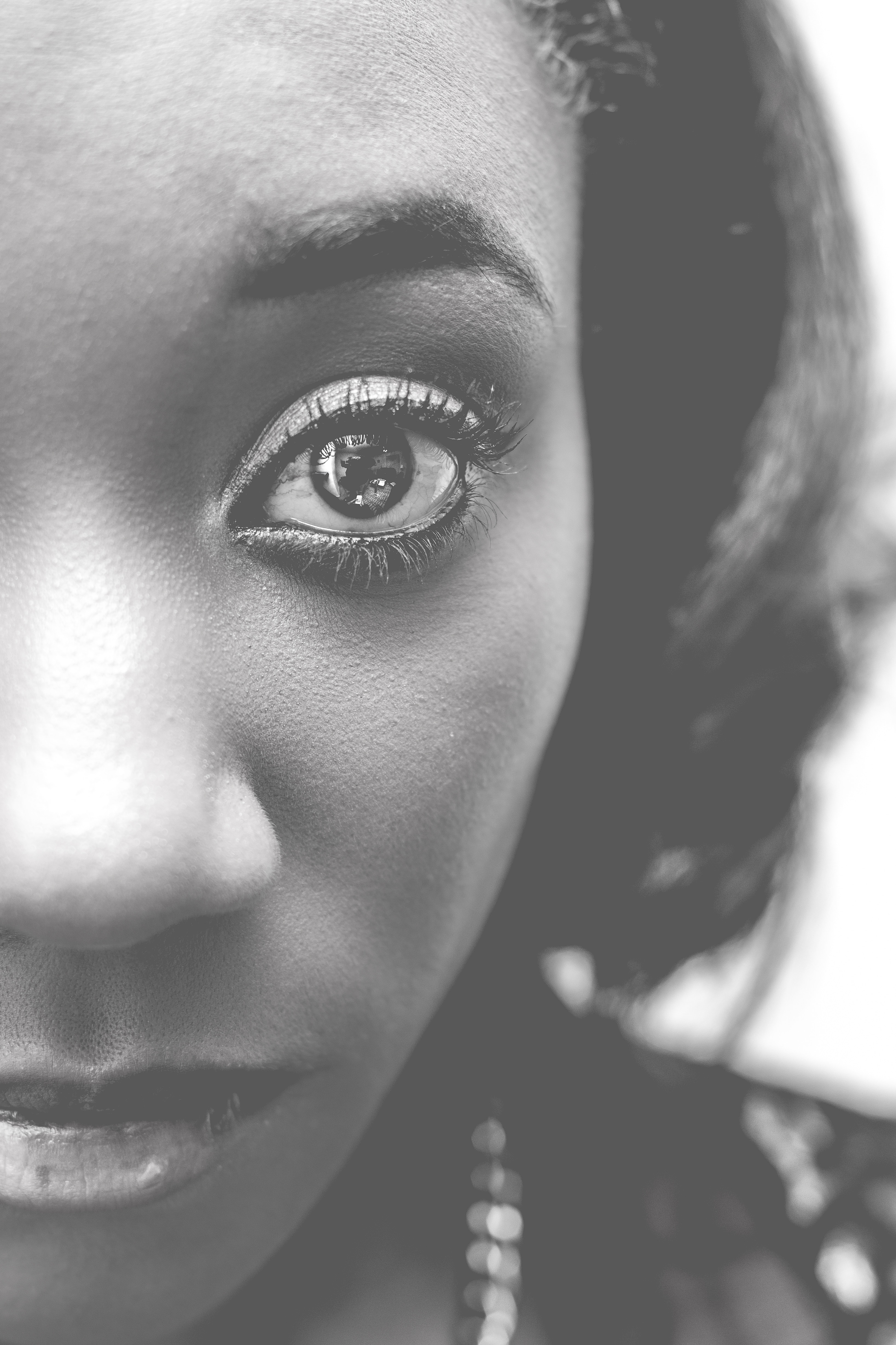 grayscale and closeup photography of woman's left eye