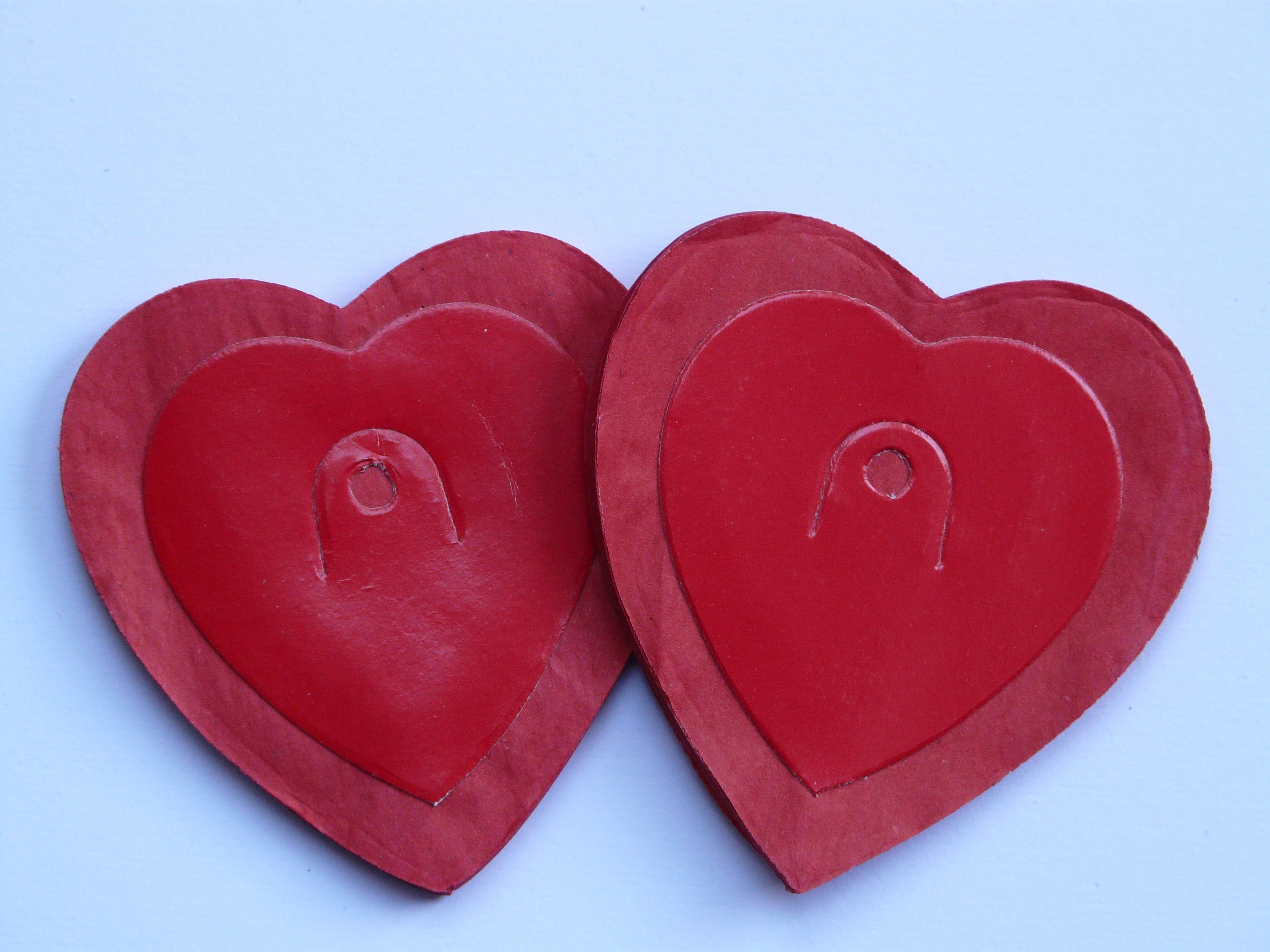 2 red wooden heart shape board