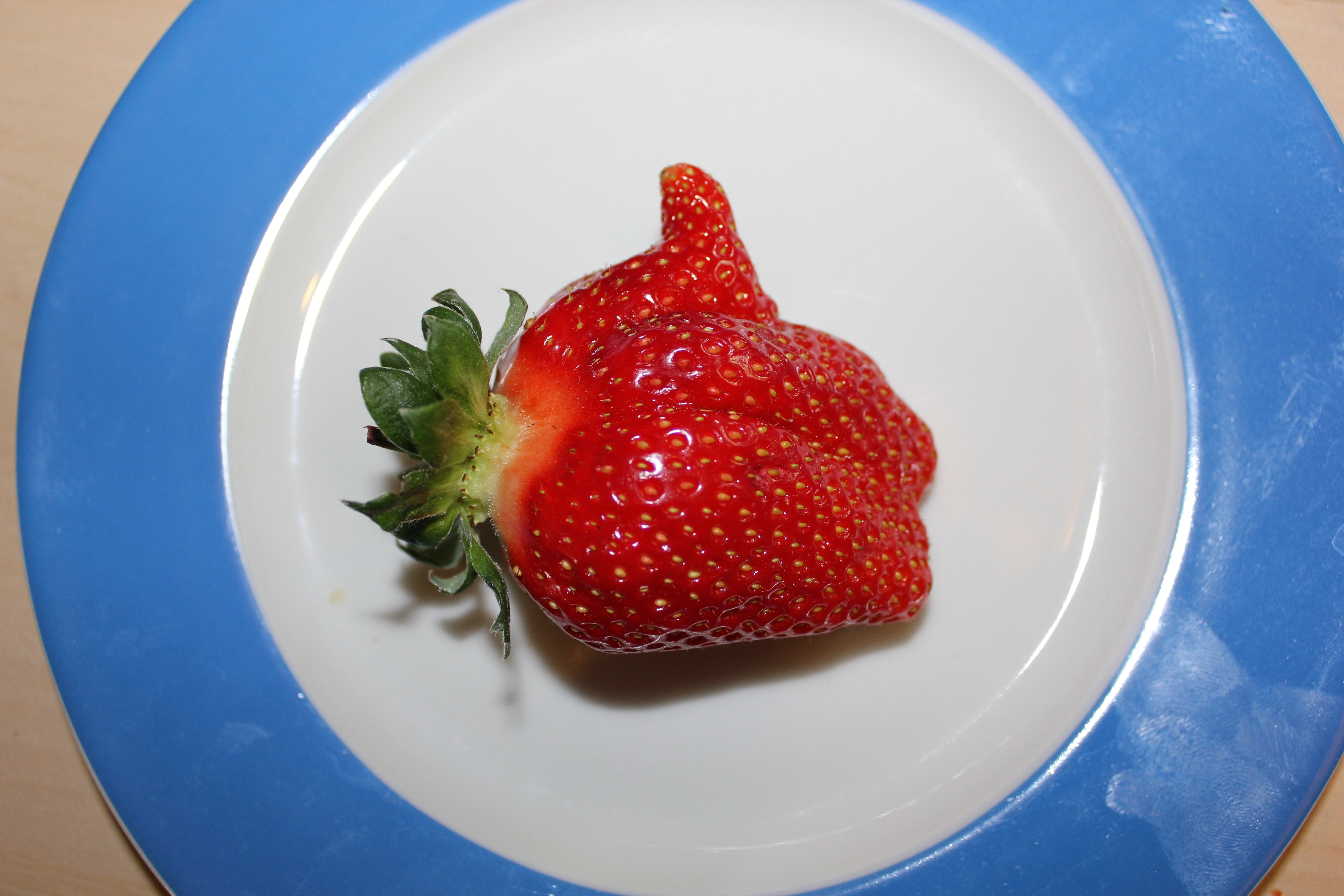 strawberry fruit and ceramic plate