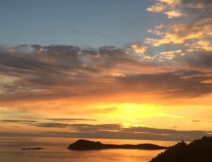 scenic view of sunset near sea thumbnail