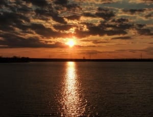 sunset by body of water thumbnail