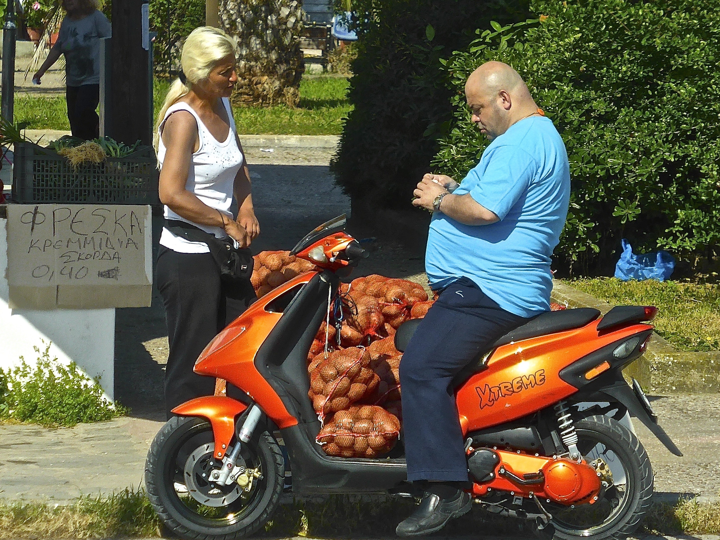 man in blue crew neck t shirt riding on orange motor scooter