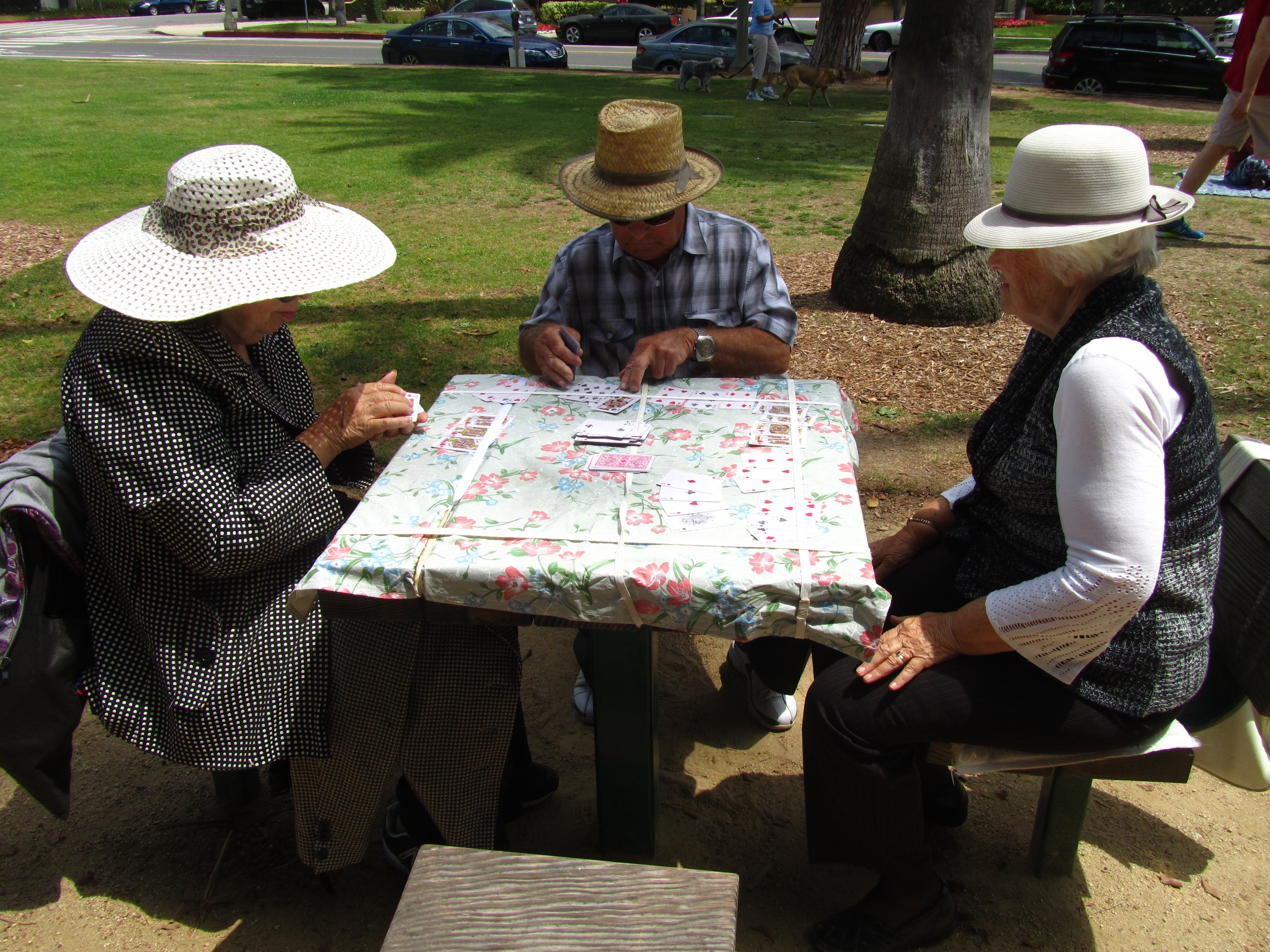three people sitting on chair playing cards
