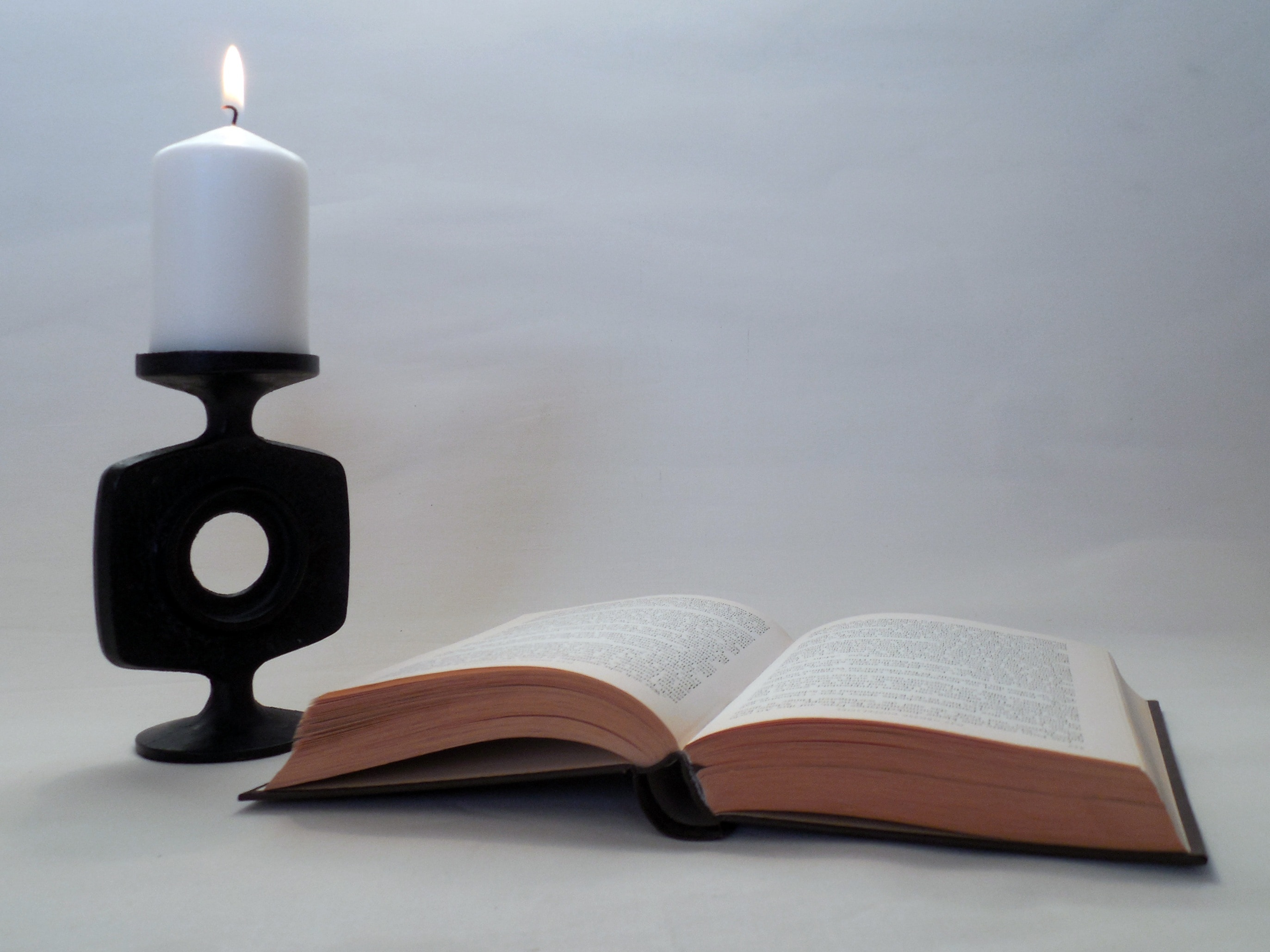 book page and pillar candle