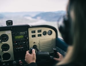 person holding steering wheel of plane in the sky thumbnail