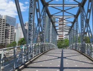 photo grey metal bridge during daytime thumbnail
