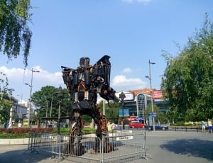 orange and black steel robot in park thumbnail