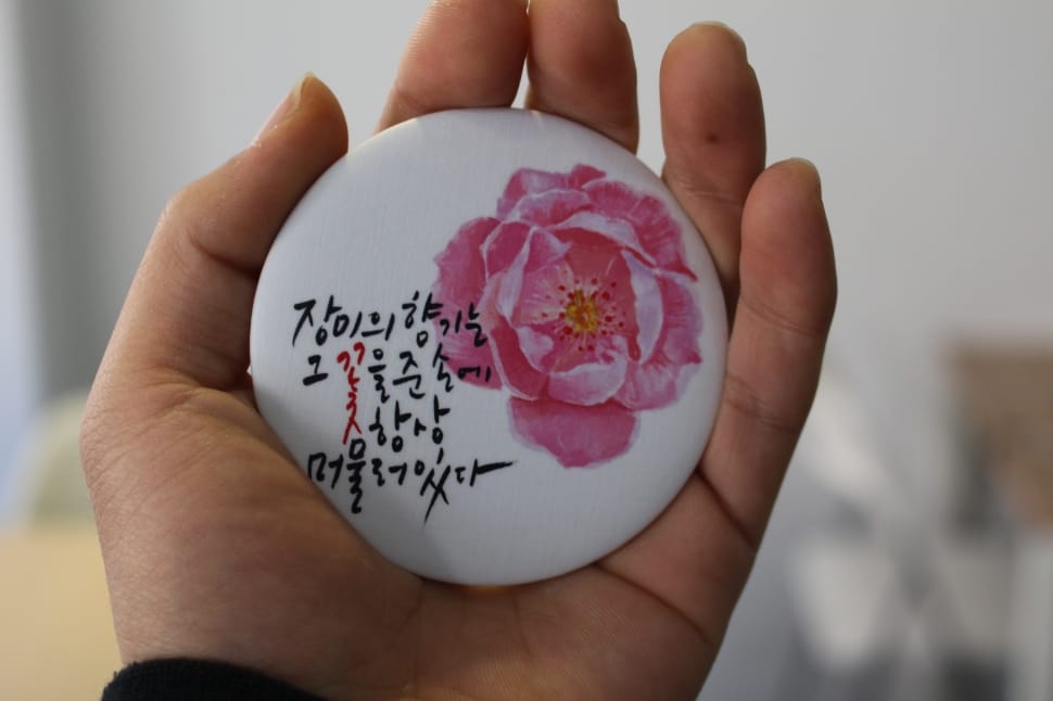 white and pink floral printed kanje text round pinback preview