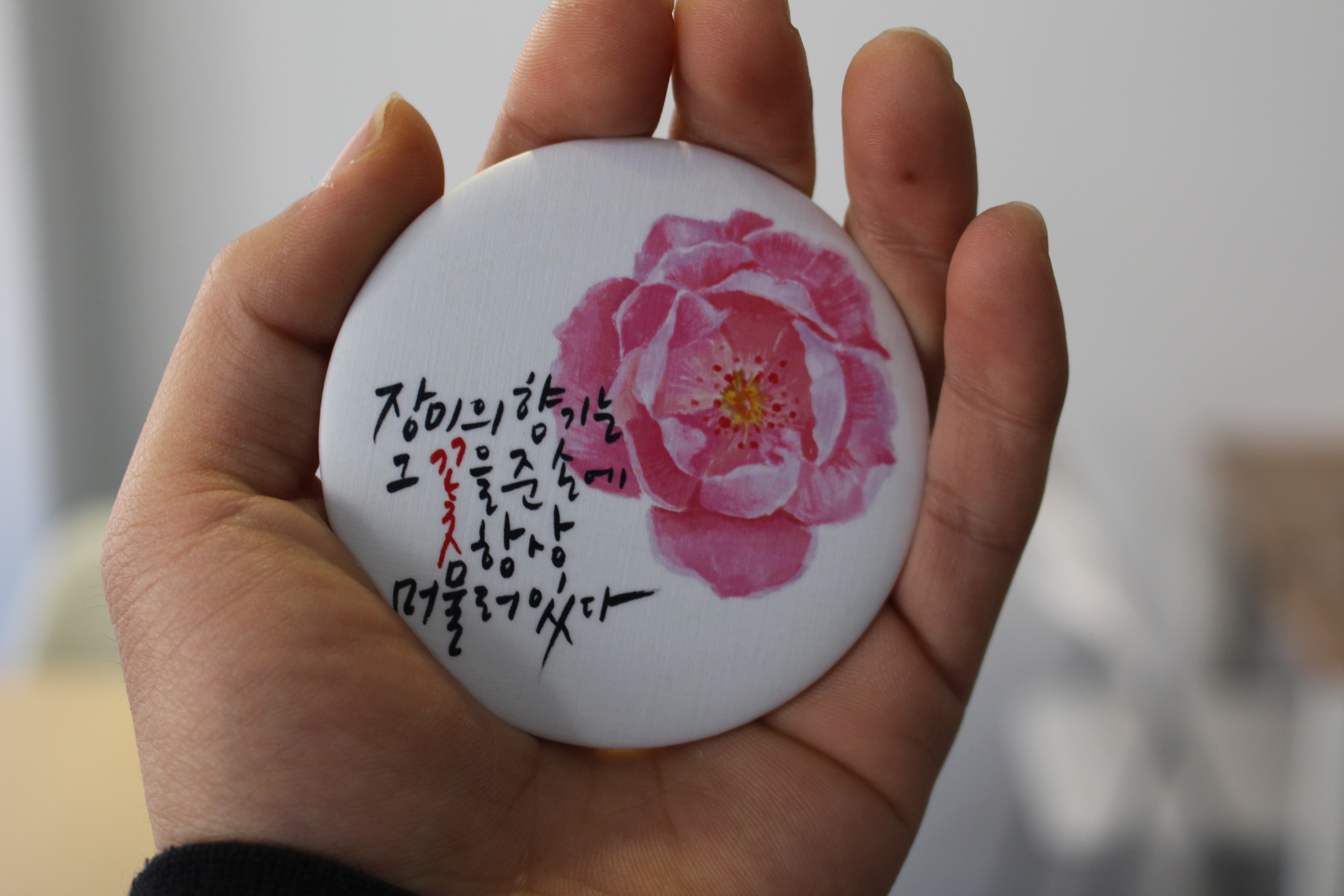 white and pink floral printed kanje text round pinback