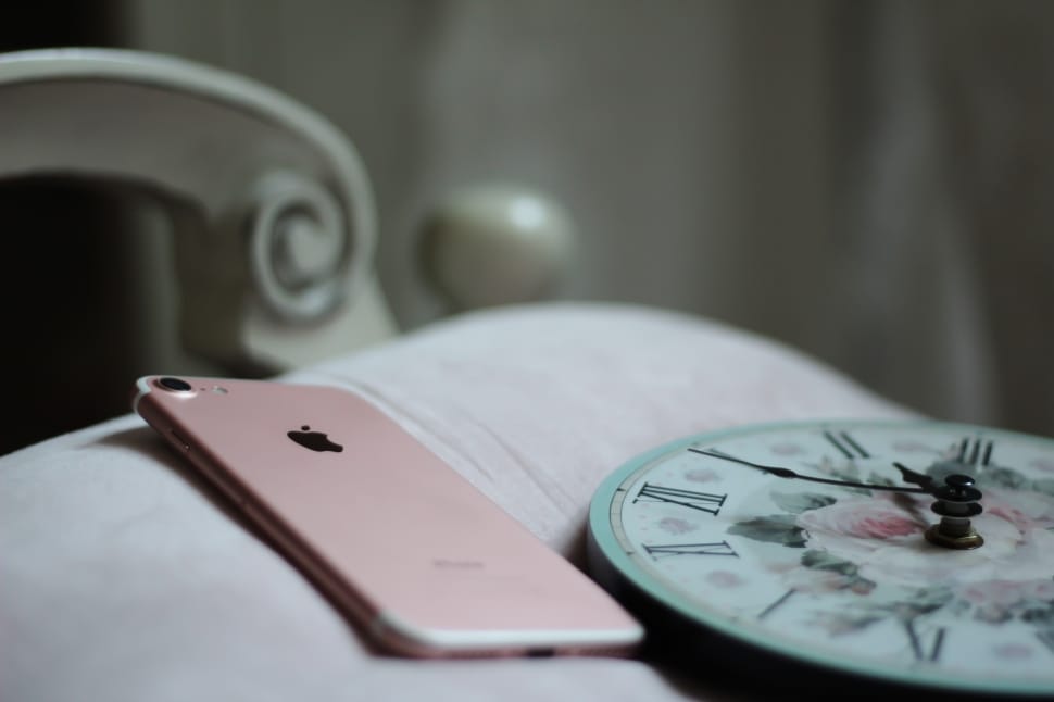 rose gold iphone 6 on white and green analog wall clock preview