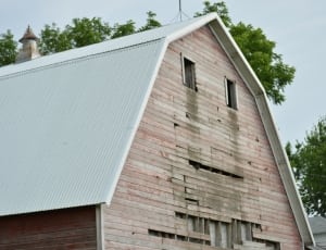 beige barn house with white roof thumbnail