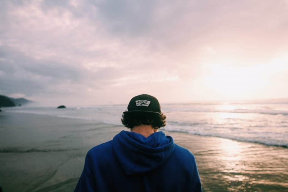 man in blue hoodie on seaside preview