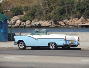 white and blue Chevrolet Bel air parked on a sidewalk thumbnail