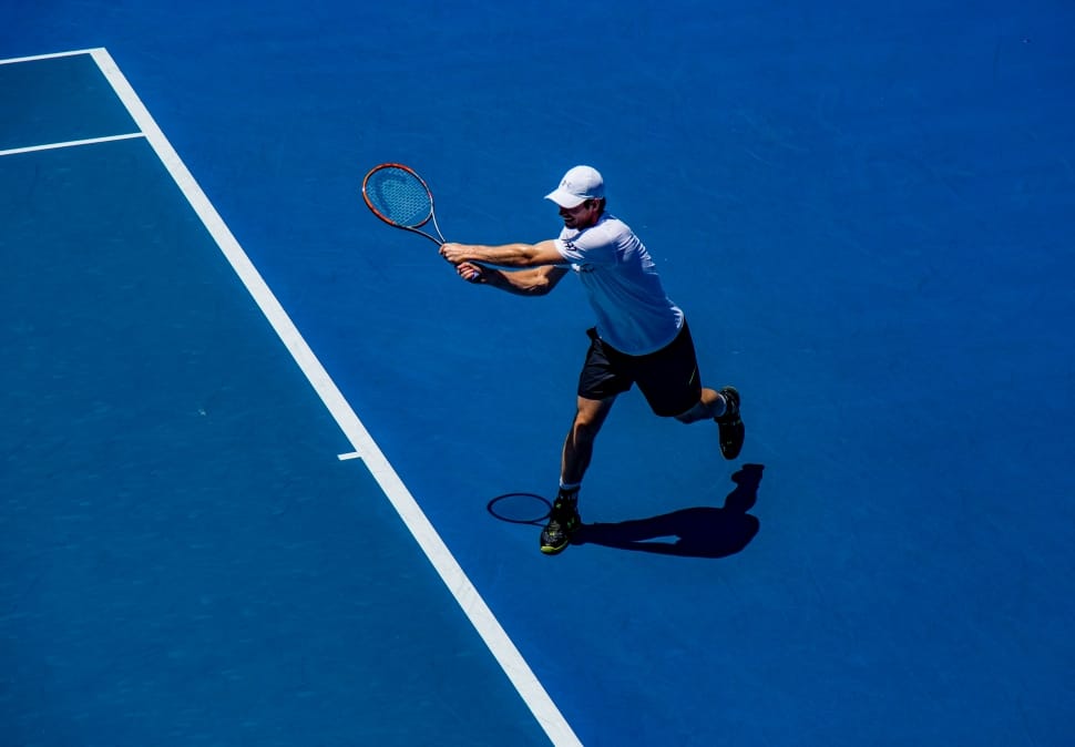 man playing tennis game in tennis court preview