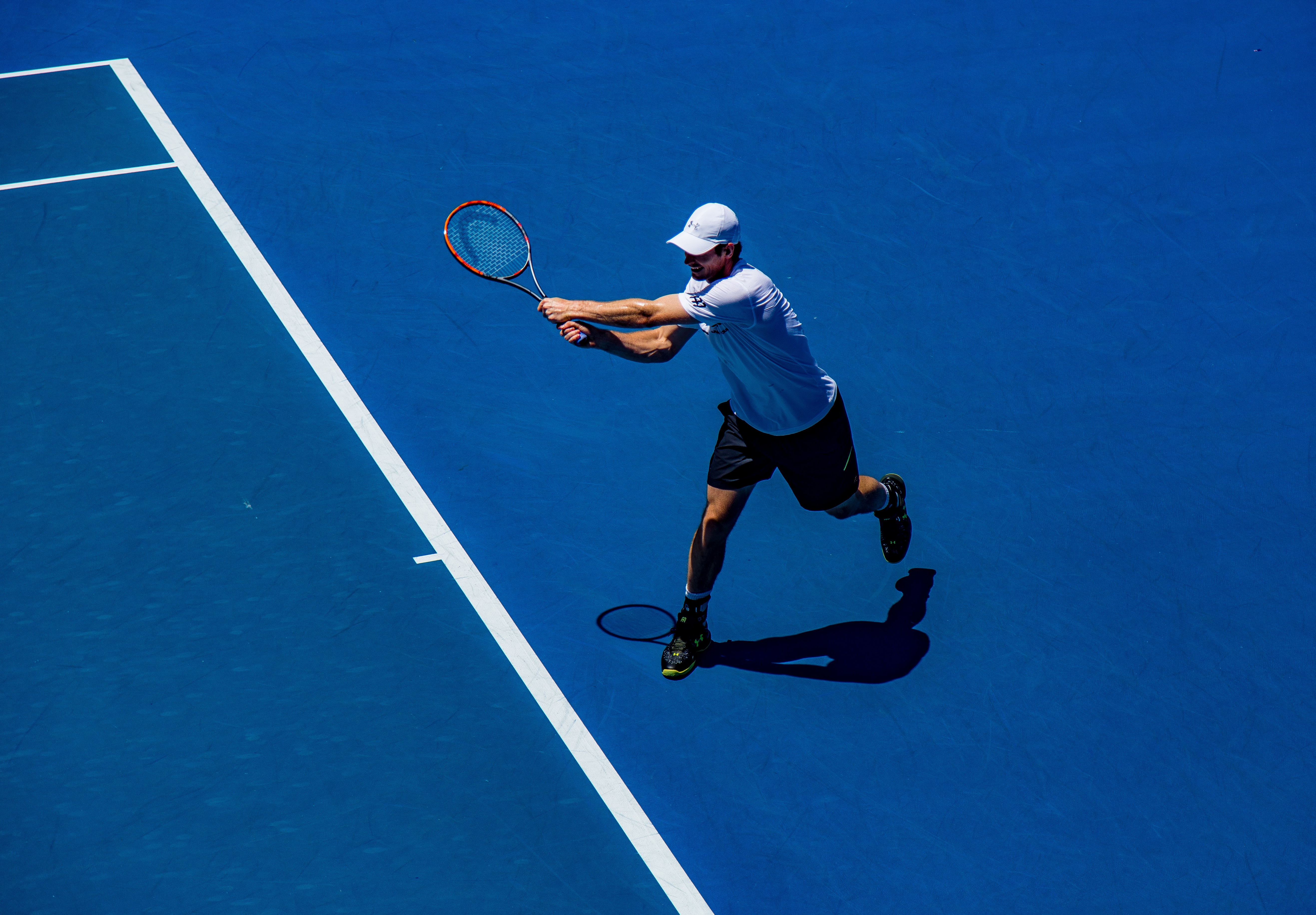 man playing tennis game in tennis court
