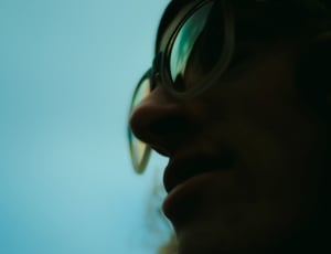 man in clear framed sunglasses close-up photography thumbnail