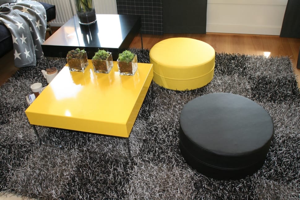 2 black and yellow round ottomans and yellow coffee table preview