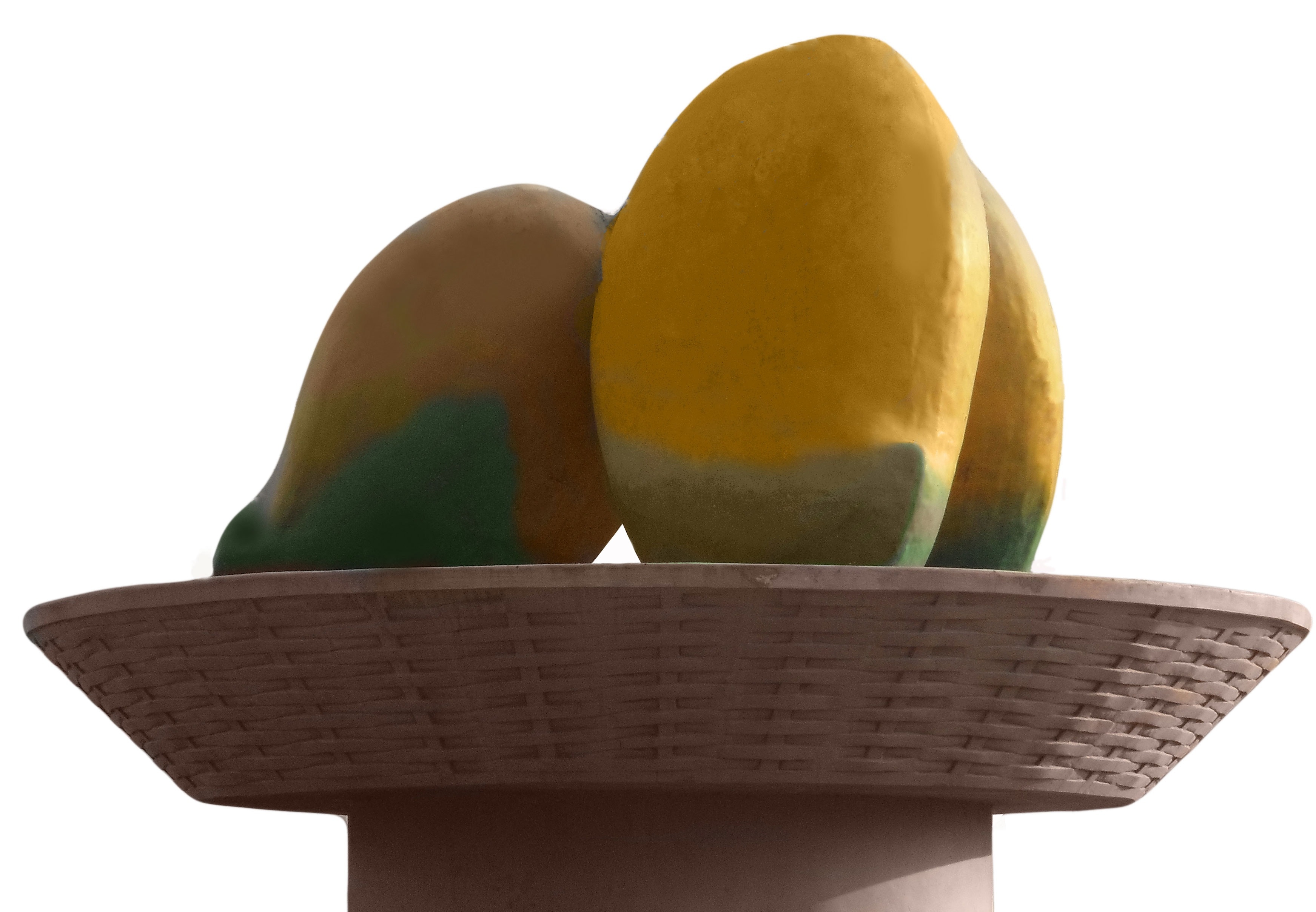 artificial yellow-green mango fruit in brown woven fruit bowl