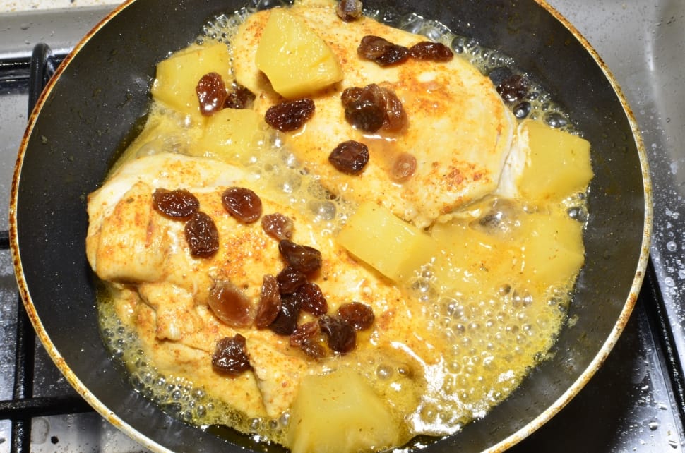 egg in black fry pan with raisins preview