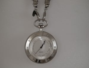 silver link chain pocket watch on top of white surface thumbnail