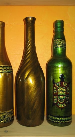 2 gold glass bottles and green glass bottle thumbnail