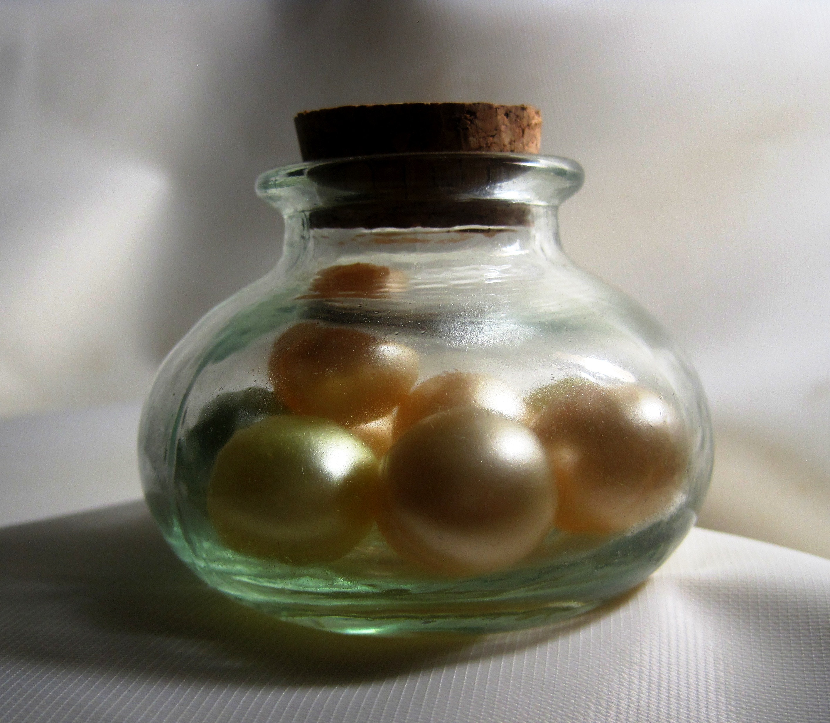 gold pearl in glass bottle