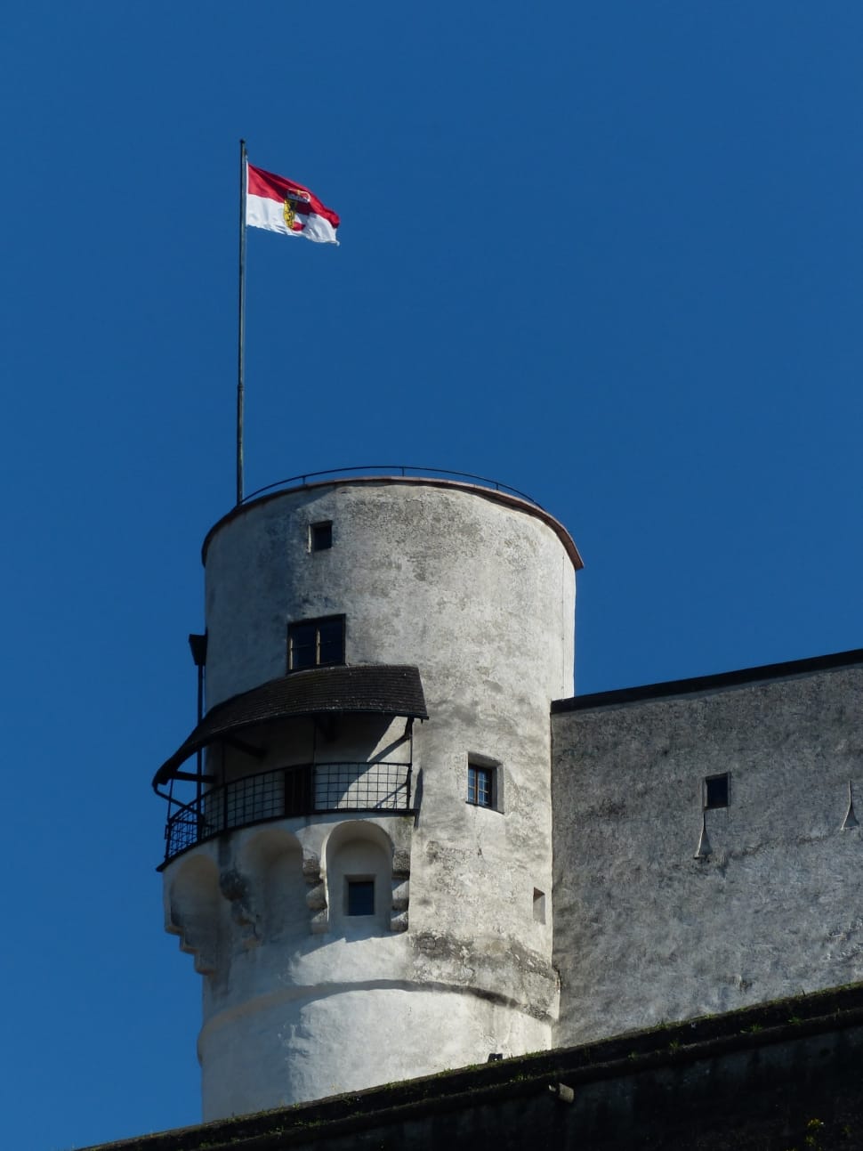 red and white flag with red castle