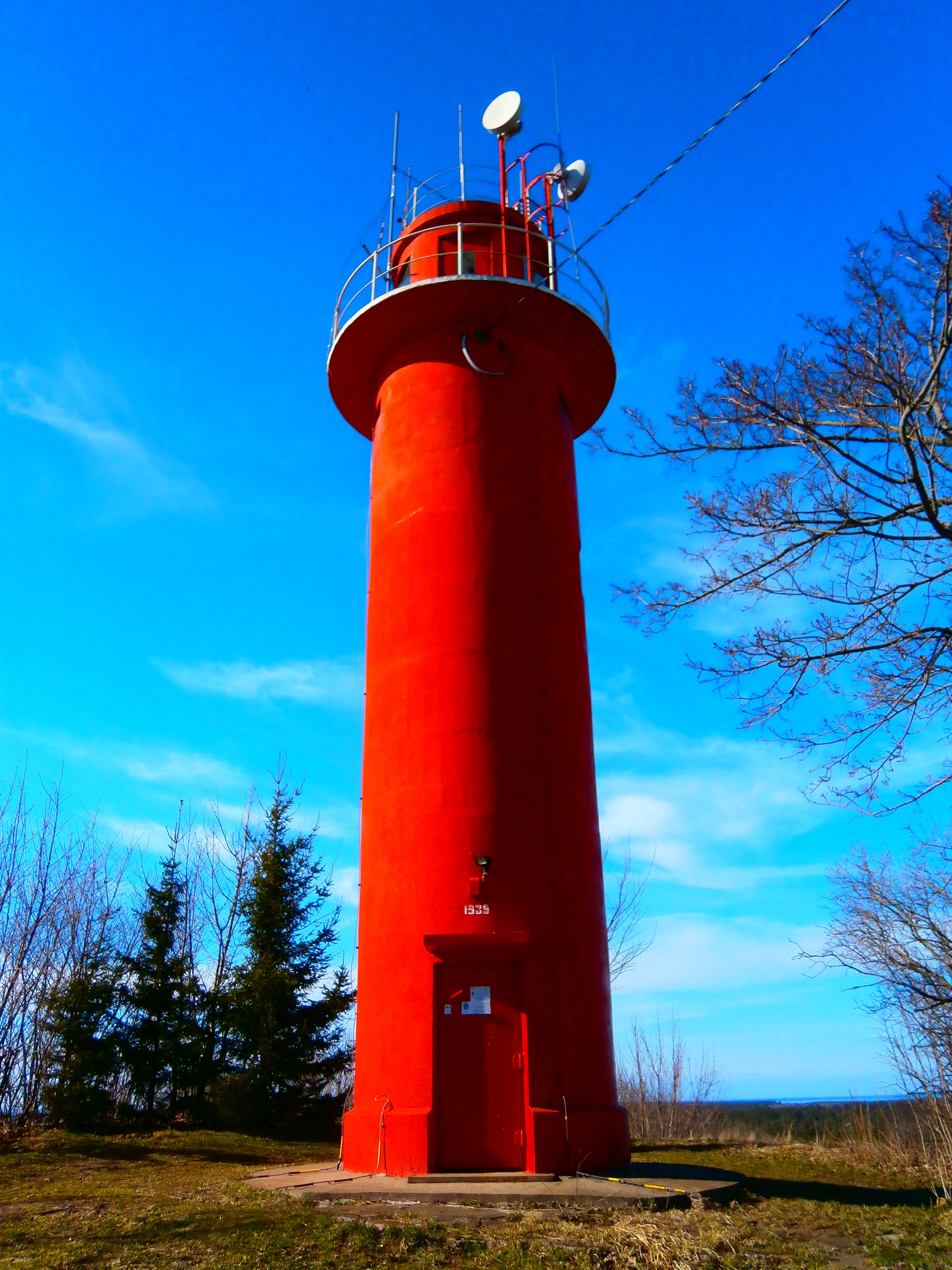 red lighthouse under blue sky during day time