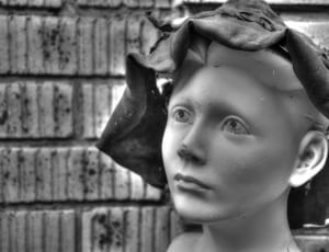 greyscale photo of woman wearing hat statue thumbnail