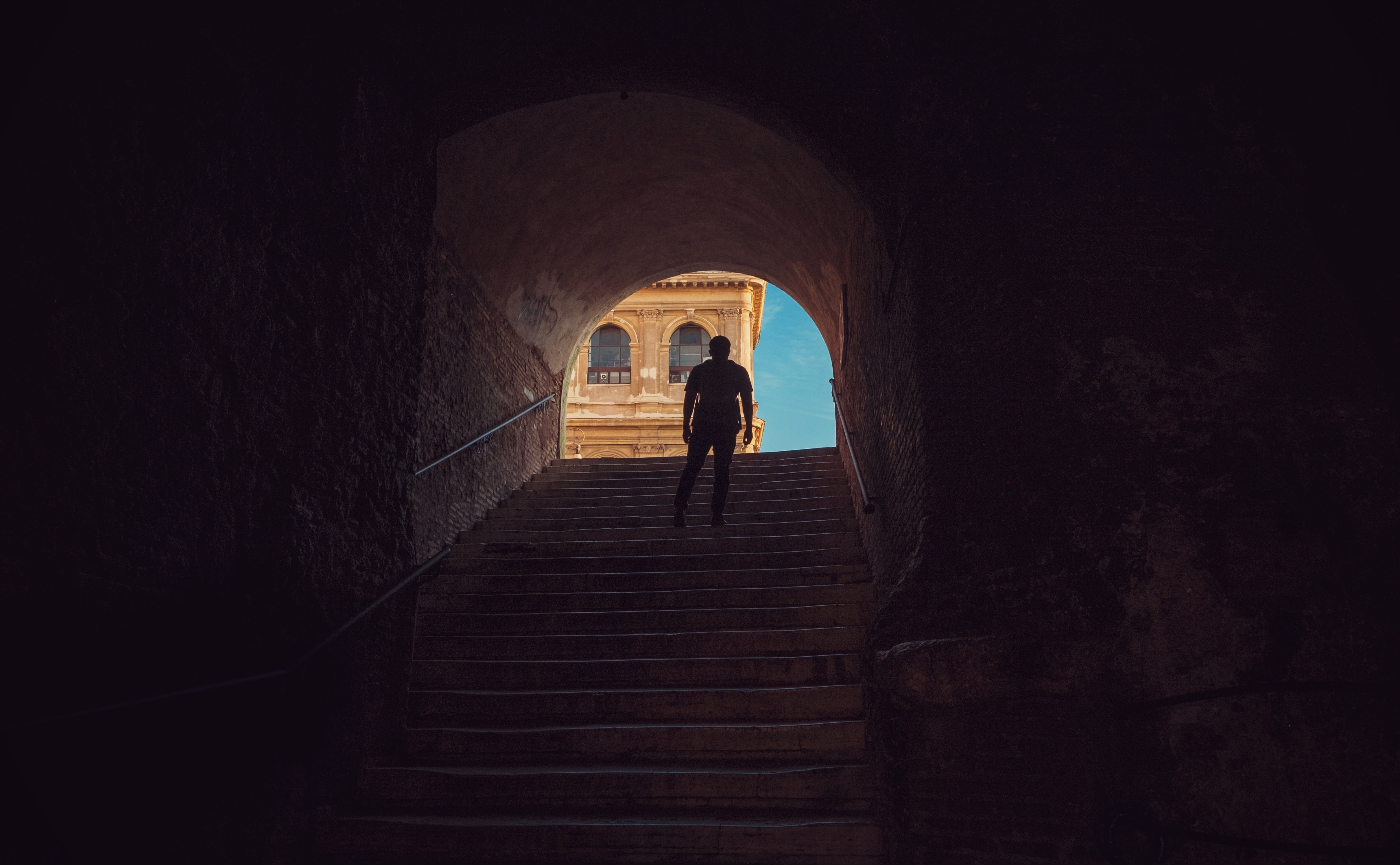 man standing on the middle of the stairs