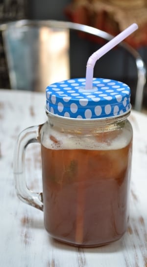 glass mason jar filled with ice tea thumbnail