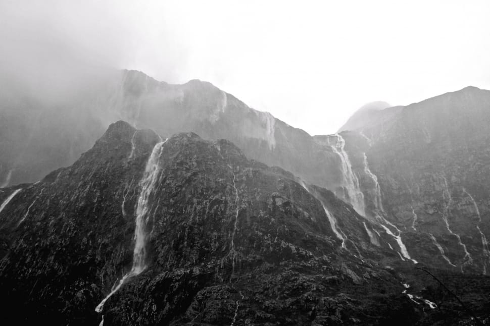 black and white photo of water falls on the mountain preview