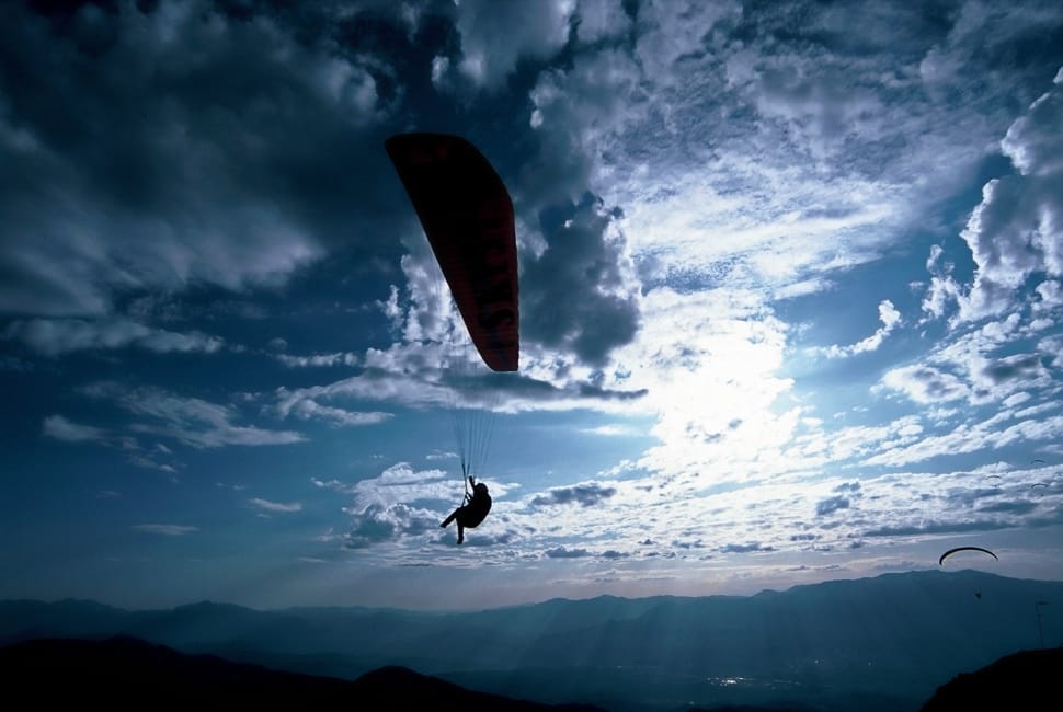silhouette of person paragliding preview