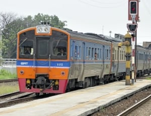 orange and gray train near station thumbnail