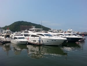 white yacht near dock on body of water thumbnail