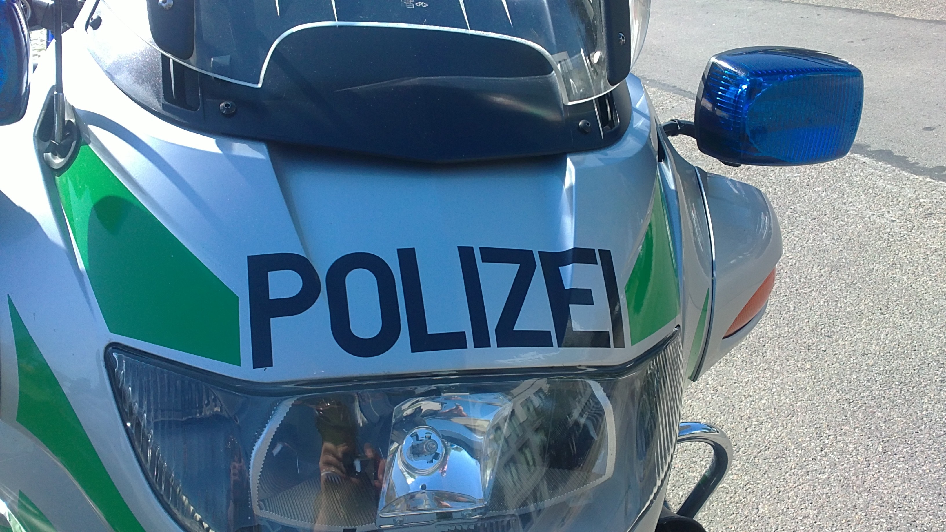 white and green police motoryccle