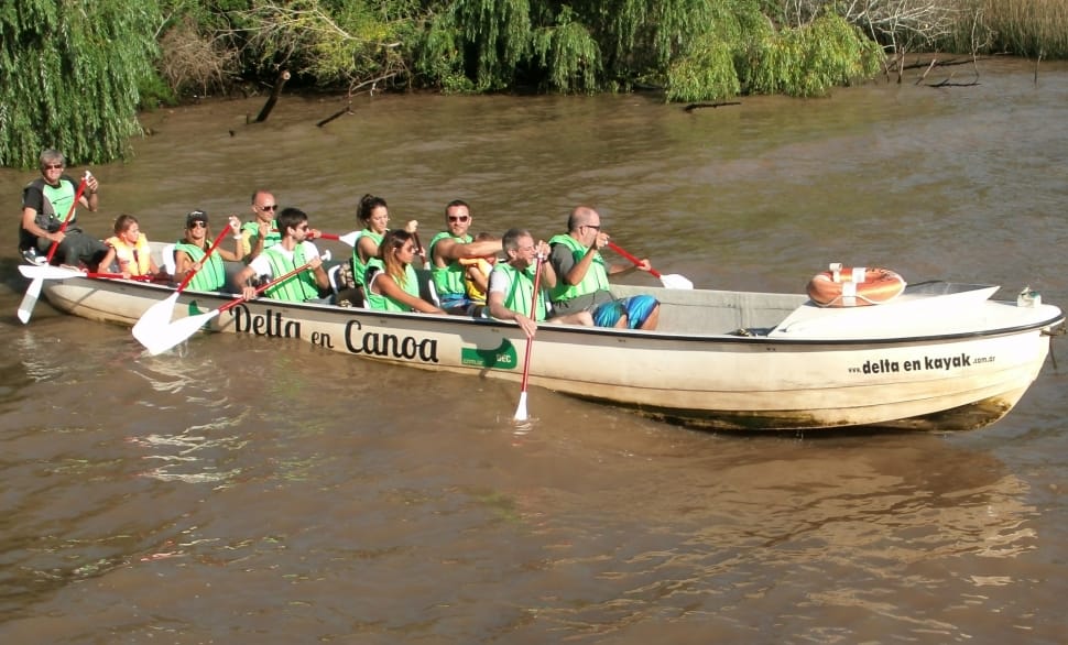 group of people riding and paddling boat preview