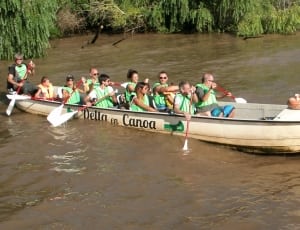 group of people riding and paddling boat thumbnail