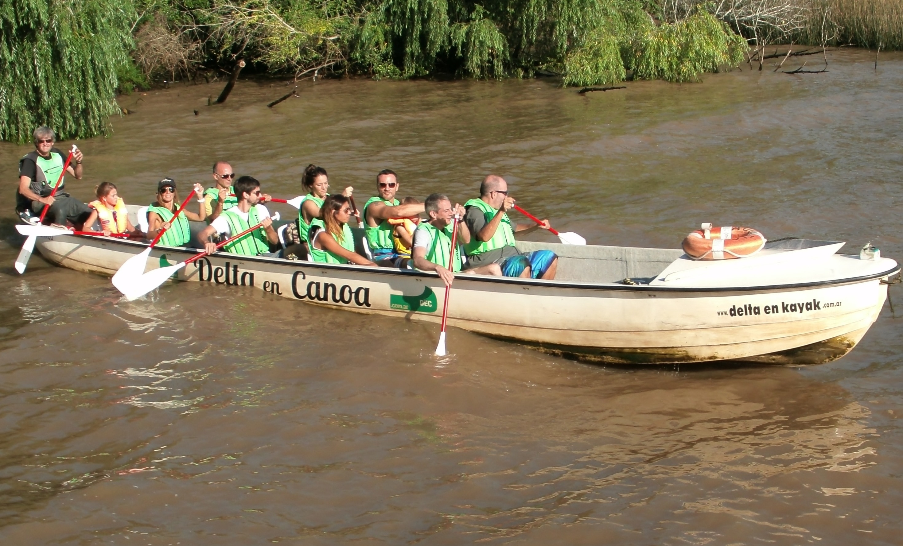 group of people riding and paddling boat