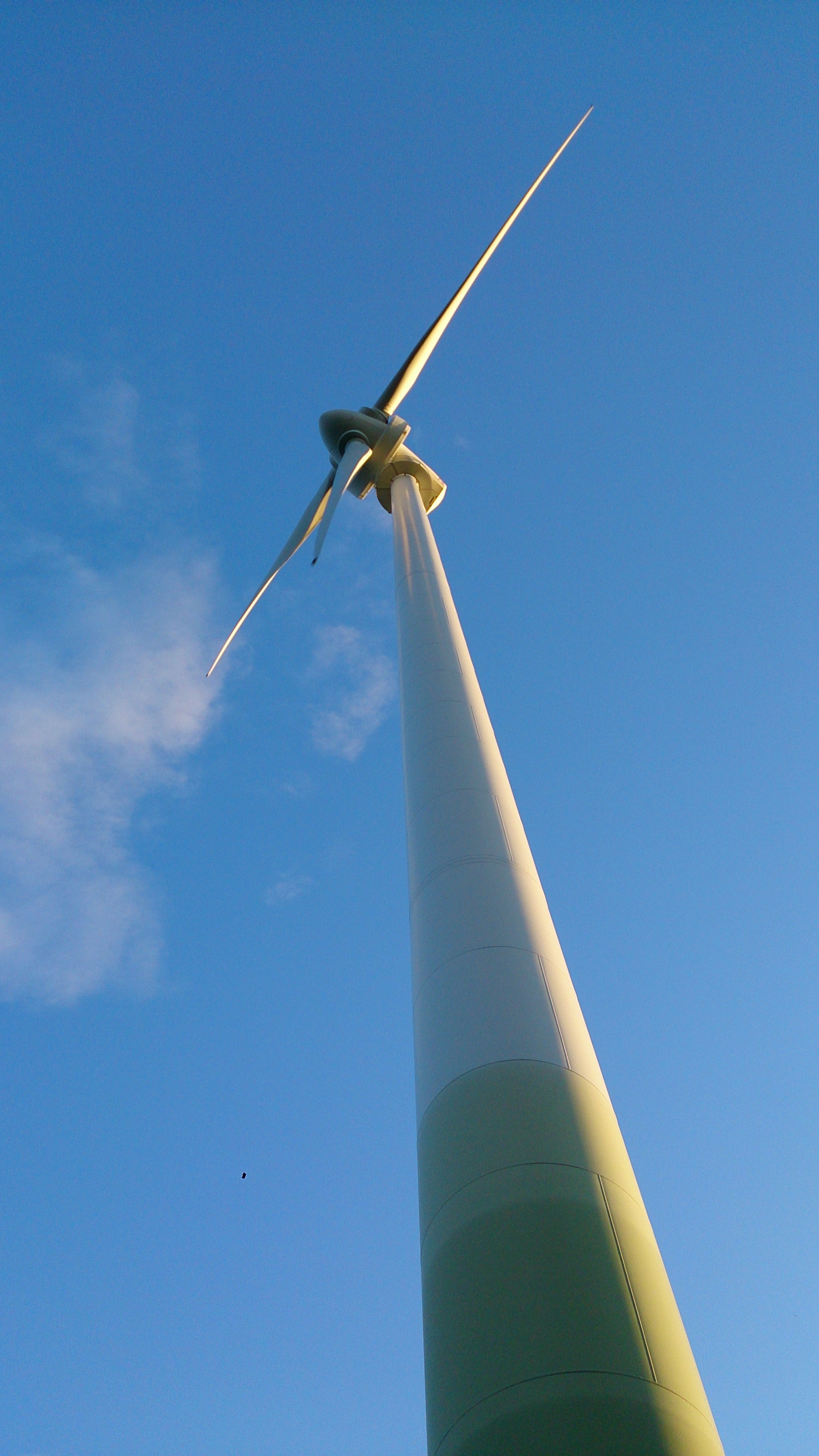 low angle photography of  wind mill under blue sky during daytime