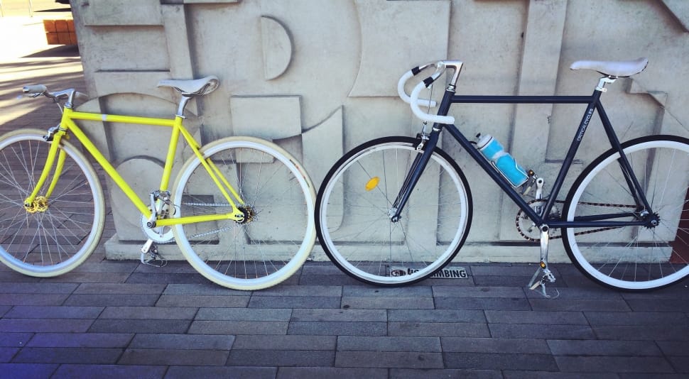 two black and yellow fixed gear bicycle preview