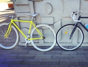 two black and yellow fixed gear bicycle thumbnail